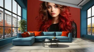 Beautiful fashion model with creative long curly hair, studio shot. Portrait of beautiful young woman in black clothes with red hair on red background. Portrait of a fashion model with bright makeup. Wall mural