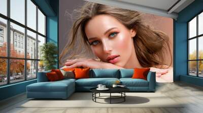 Beautiful white girl with red lips looks to the camera. Stunning blonda girl. Closeup face of young beautiful woman with a healthy clean skin. Pretty woman with bright  makeup of eyes. Wall mural