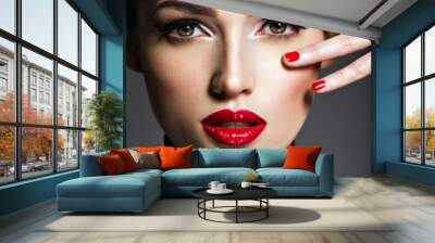 Beautiful woman with bright make-up and red nails. Wall mural