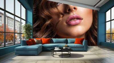 Beautiful woman with brown hair. Beautiful face of an attractive model with fashion makeup. Woman with beauty long curly  hair. Closeup portrait of a caucasian female. Stunning girl. Wall mural