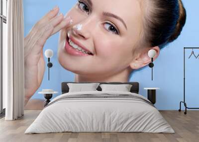 Beautiful young  woman with cream on her nose Wall mural