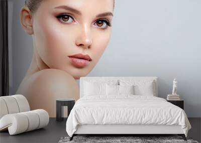 Closeup portrait of a  face of the young pretty girl with a healthy skin. Beautiful face of young white woman with a clean skin. Skin care concept. Wall mural