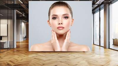 Closeup portrait of a  face of the young pretty girl with a healthy skin. Beautiful face of young white woman with a clean skin. Skin care concept. Wall mural