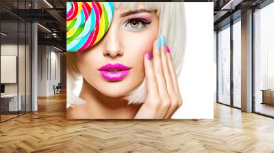 Face of a beautiful  girl with pink eye make-up and multicolor nails. Sweet candy. Wall mural