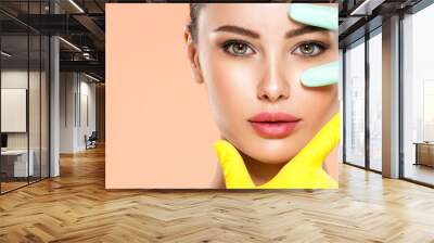 Face skin check before plastic surgery. Beautician touching young woman face. Doctor in medicine gloves checks a skin before plastic surgery. Beauty treatments. Wall mural