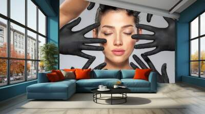 Face skin check before plastic surgery. Medical doctors are checking a face of a woman before botox injection. Surgeries' hands in medical gloves near the women face.  Beauty treatments. Wall mural