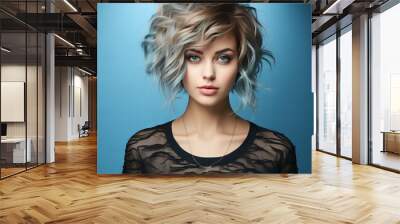 Fashion portrait of beautiful young woman with short hairstyle and professional make up. Beautiful fashion model with stylish hairstyle, studio shot. Fashion model in blue clothes with bright makeup Wall mural