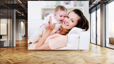 Happy mother with little baby Wall mural