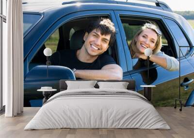 happy young couple driving the car Wall mural