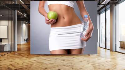 Healthy female body with apple and water Wall mural