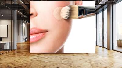 Makeup artist applying liquid tonal foundation  on the face Wall mural