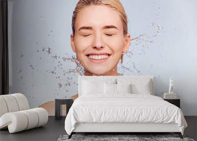 Photo of  young  woman with clean skin and splash of water. Portrait of smiling woman with drops of water around her face. Spa treatment. Girl washing her body with water. Water and body. Wall mural