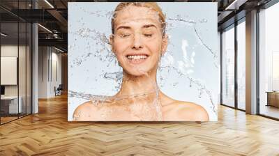 Photo of  young  woman with clean skin and splash of water. Portrait of smiling woman with drops of water around her face. Spa treatment. Girl washing her body with water. Water and body. Wall mural