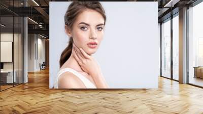 Portrait of a beautiful young woman with a brown hair. Wall mural