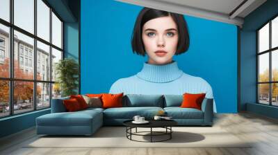 Portrait of a beautiful young woman with short black hair on blue background. Portrait of an attractive brunette girl with short hair, front view. Caucasian pretty lady looks at camera. AI generated Wall mural