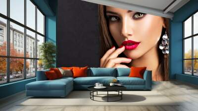 seductive woman with dark brown eye makeup and bright red lips and nails Wall mural