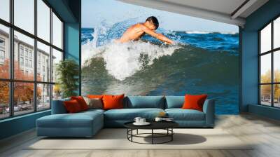 Teenager  boy enjoying a swimming in the sea. Wall mural