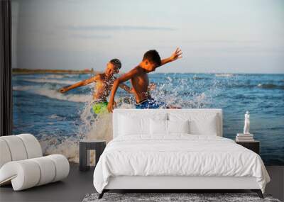 Two boys adolescence playing in the sea water splashing feet wat Wall mural