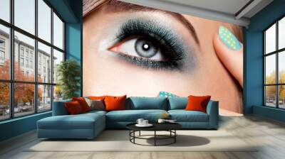 woman's eye with turquoise makeup. Long false eyelashes. macro s Wall mural