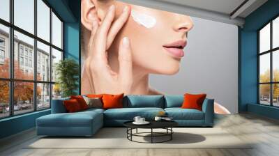 woman gets cream in the face. Skin care concept. Wall mural