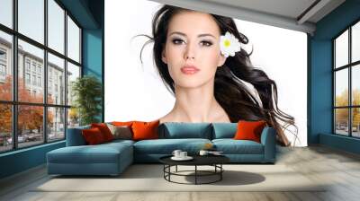 Woman with clean skin and flowers in her long hair Wall mural