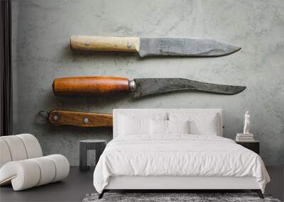 Old knifes on a grey background,Top view Wall mural