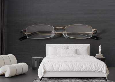 Glasses lie on a grey wooden table Wall mural