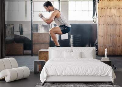 Dont skip leg day. Shot of a young man doing leg exercises at gym. Wall mural