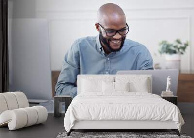 Laptop, writer and black man with notebook, smile and working on business project in office. Computer, happy and African professional taking notes, copywriting or research, planning and reading email Wall mural