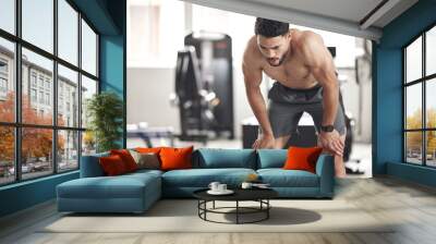 Man, bodybuilder and tired at gym for fitness with weightlifting for muscles, strength and health. Male person, body and sweat on break with exercising, training and workout for self care or wellness Wall mural