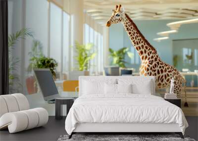 A giraffe sits at a desk working on a computer in a modern office space, with plants and light filtering in. Wall mural