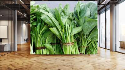 Kale and Chinese Cabbage are harvested from organic farms. Chinese kale has thick, dark green leaves. Choi sum has thin green leaves with small yellow flowers. Vegetables are wrapped with natural rope Wall mural