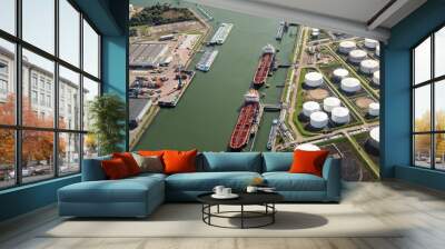 Tankers moored at an oil terminal with storage silo's in the Port of Rotterdam. Wall mural