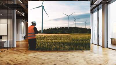 Engineer working at alternative renewable wind energy farm - Sustainable energy industry concept Wall mural