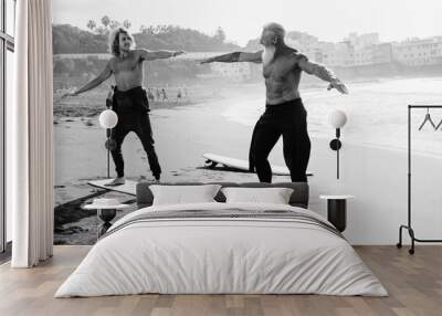 Father and son surfers having fun during surf lesson at the beach - Extreme sport concept - Black and white editing Wall mural