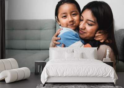 Happy Latin American mother and son hugging each other at home - Family love concept - Focus on child face Wall mural