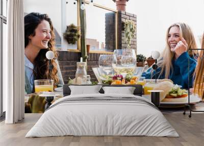 Happy people eating vegan food dinner outdoor at patio restaurant - Focus on right girl face Wall mural