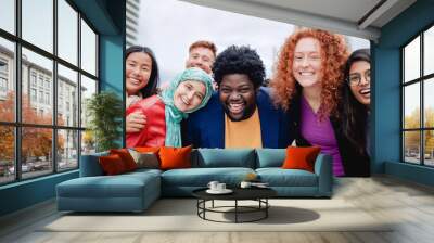 Multiracial happy group of friends having fun outdoors in the city - Focus on curvy african man face Wall mural