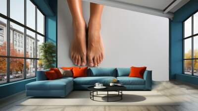 Female feet with pedicure on grey background. Top view. Flat lay. Banner design. Wall mural