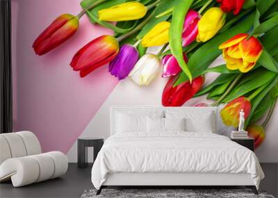 bouquet of beautiful colored tulips on a pink delicate background. greeting card for women's day. 8 March., Mother's Day. Flat lay and copy space Wall mural