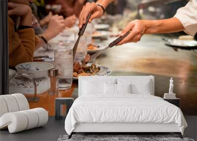 Hand of professional chef cooking beef steak on hot pan, in front of Customer Wall mural