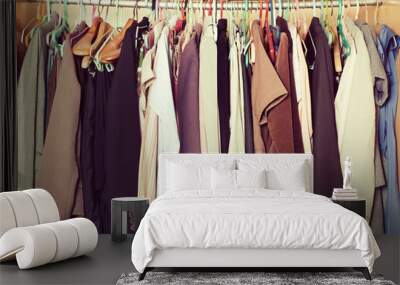 Pile of messy clothes in closet. Untidy cluttered woman wardrobe in vintage style. Wall mural