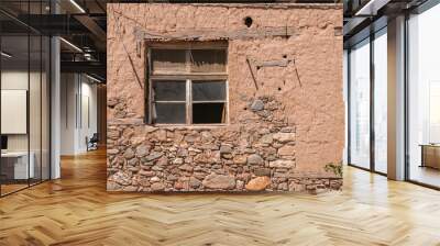 Old weathered broken window on neglected adobe clay rural house wall Wall mural