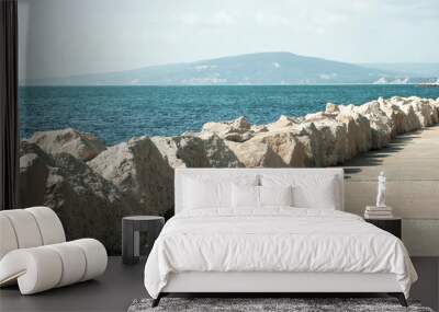 Seaside promenade with white stones on clear sunny summer day Wall mural