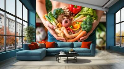 a person holding heathy foods over their stomach representing a healthy gut flora and probiotics. Wall mural