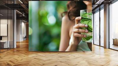 glass of cucumber and mint-infused water, highlighting the rejuvenating effects of natural ingredients. Wall mural