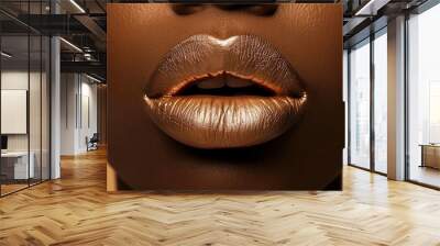 Close-up of metallic gold lips on dark complexion, showcasing vibrant makeup artistry against a soft golden background. Wall mural