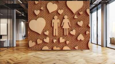 wooden hearts of different sizes and figurines of a man and a woman on jute fabric as a Valentine's day card. Declaration of love. High quality photo Wall mural