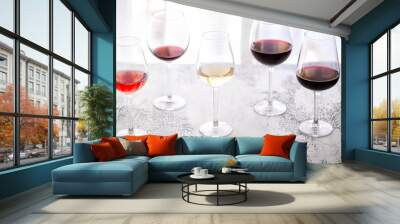 Glasses with different wine bordeaux, red, rose  and white on white background. Beautiful wine variety concept. Wall mural