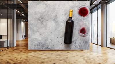 Red wine bottle with red wine glass  on concrete background. Top view Copy space. Wall mural